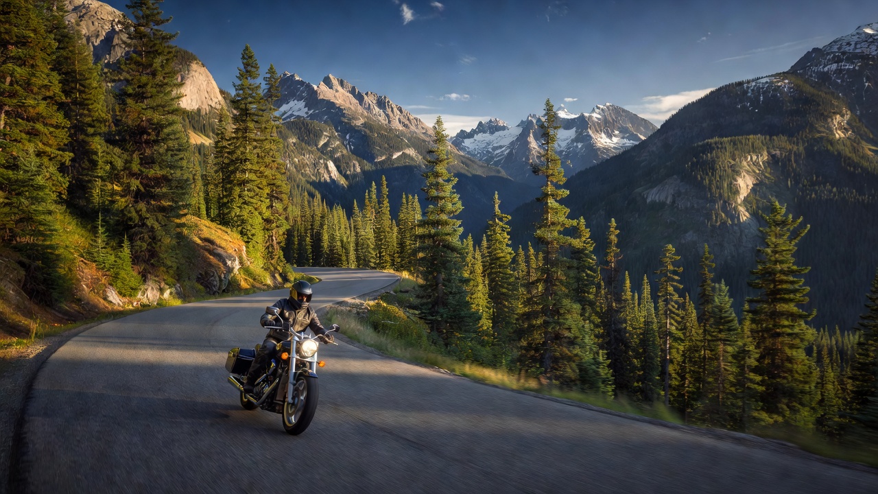 Motorcyclist riding on a mountain highway in British Columbia, Canada